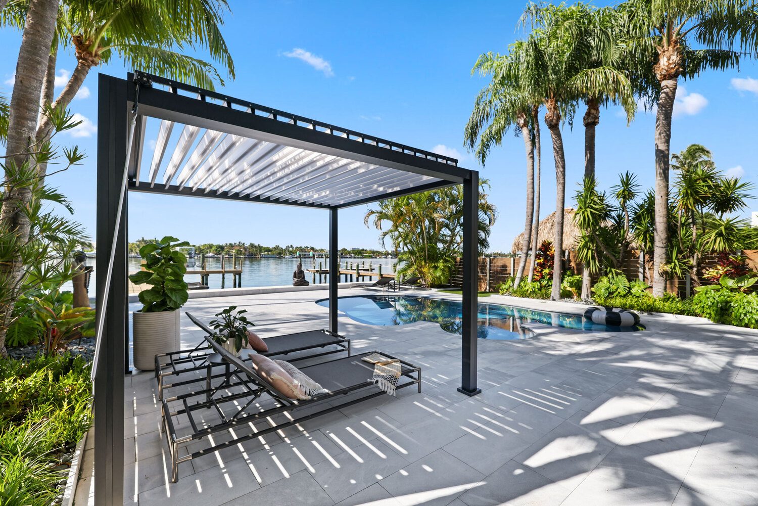 Outdoor pergola with Portland Window Coverings near pool and waterfront in Tigard, OR